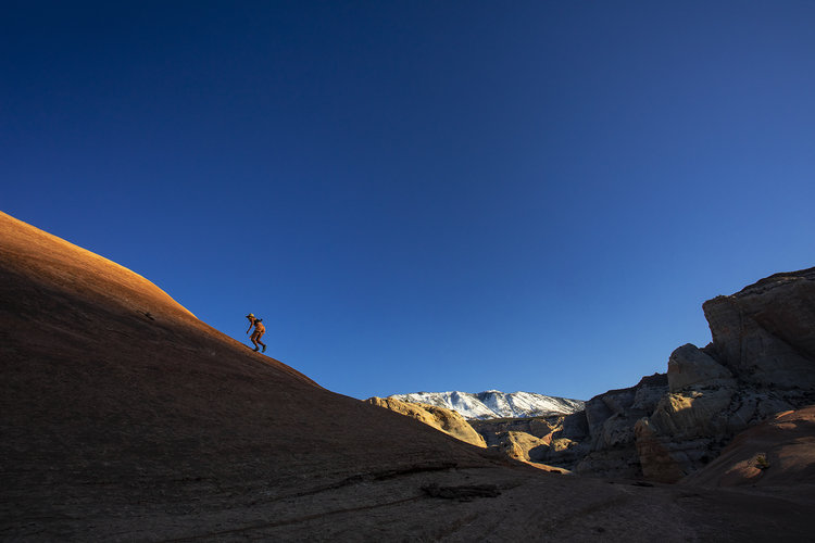 Exploring the expanse of slick rock domes near the Rainbow Trail. Photo by Stephen Eginoire